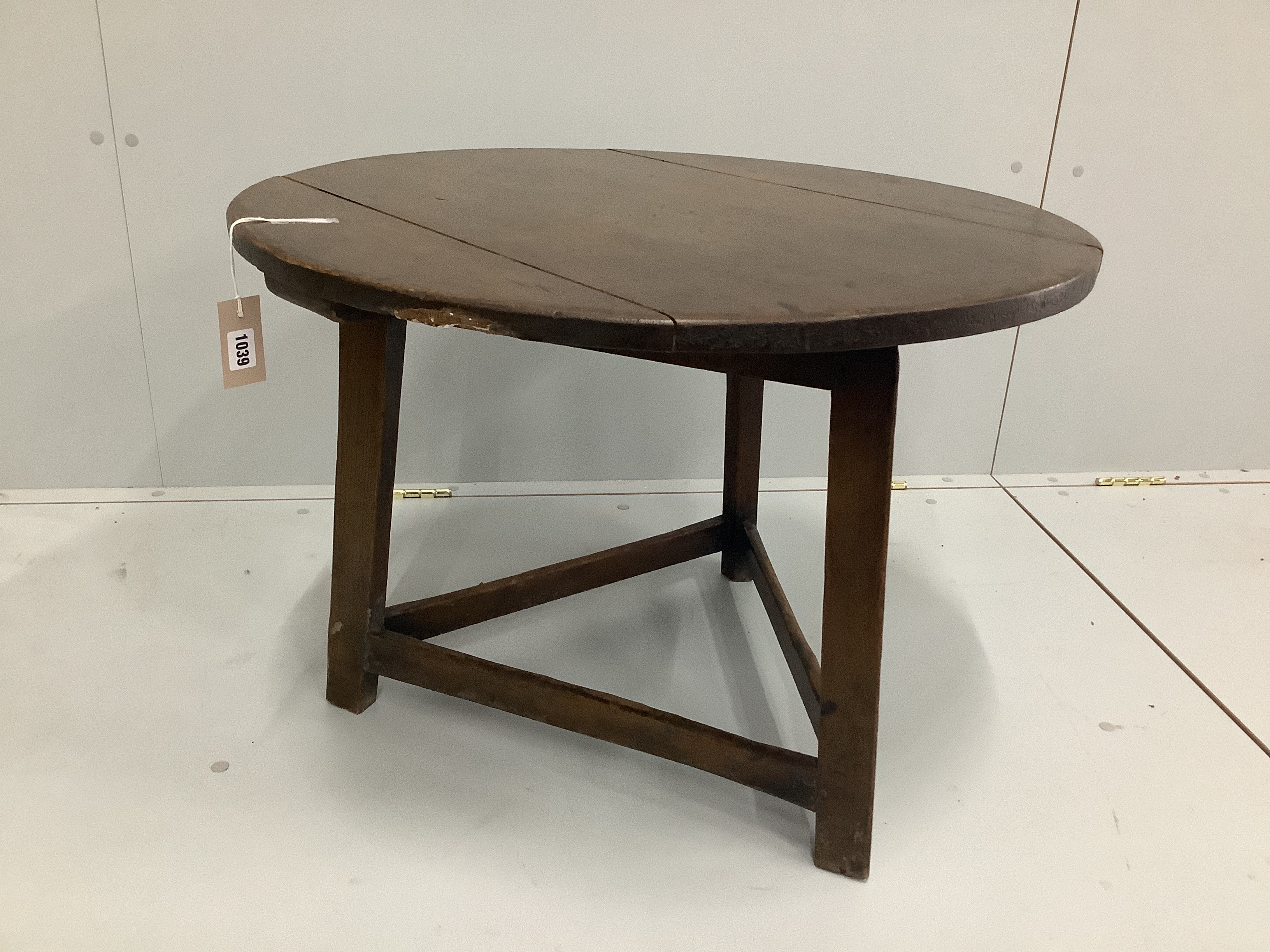 A 19th century and later circular oak and fruitwood cricket table, reduced, diameter 72cm, height 50cm